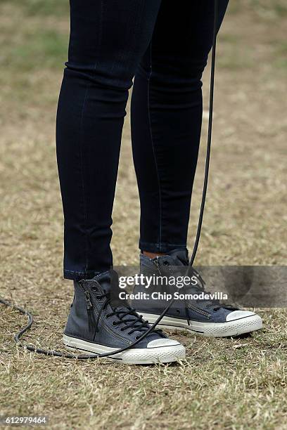 First lady Michelle Obama, shoe detail, speaks to students and guests during a harvesting event at White House Kitchen Garden on the South Lawn of...