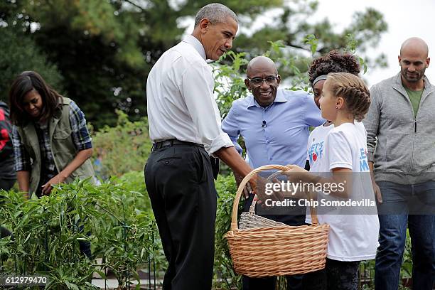 First lady Michelle Obama, President Barack Obama, NBC Today show host Al Roker and NBC News senior food analyst Sam Kass work with students to...