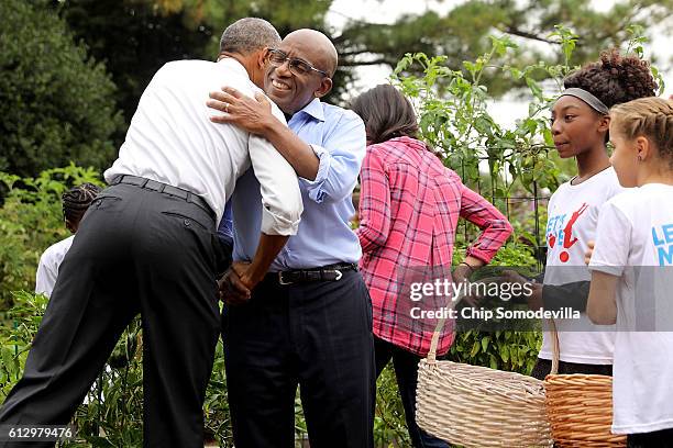 President Barack Obama embraces NBC Today show host Al Roker during an event to harvest the White House Kitchen Garden on the South Lawn of the White...