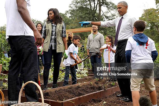 First lady Michelle Obama and President Barack Obama host an event to harvest the White House Kitchen Garden on the South Lawn of the White House...