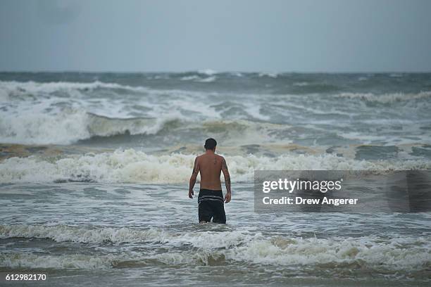 Tyler Deleshaw wades into the surf on Daytona Beach, October 6, 2016 in Daytona Beach, Florida. With Hurricane Matthew approaching the Atlantic coast...