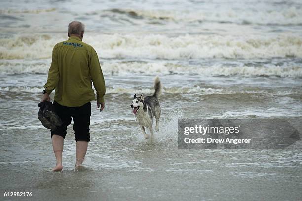 Man wades into the ocean along the shoreline of Daytona Beach, October 6, 2016 in Daytona Beach, Florida. With Hurricane Matthew approaching the...