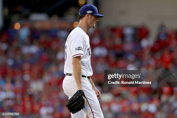 Cole Hamels of the Texas Rangers walks back to the dugout after being relieved during the fourth inning in game one of the American League Divison...