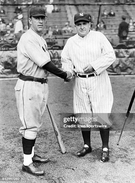 Charlie Grimm manager of the Chicago Cubs shakes hands with Joe McCarthy, Yankees manager, before the start of the World Series on September 28, 1935...