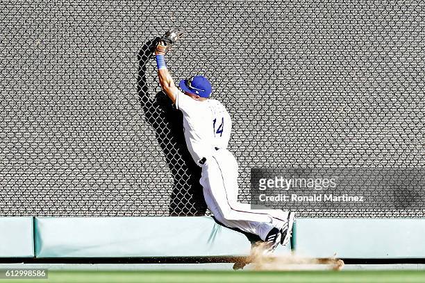Carlos Gomez of the Texas Rangers catches a fly ball in left field hit by Edwin Encarnacion of the Toronto Blue Jays during the sixth inning in game...