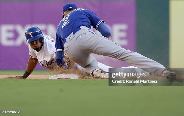 Troy Tulowitzki of the Toronto Blue Jays tags out Elvis Andrus of the Texas Rangers at second base during the sixth inning in game one of the...