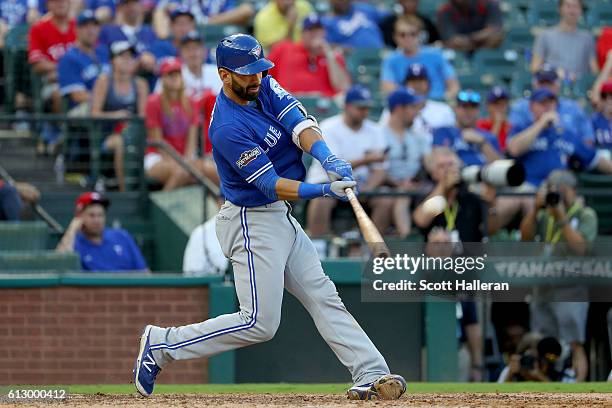 Jose Bautista of the Toronto Blue Jays hits a three run home run to left field against Jake Diekman of the Texas Rangers during the ninth inning in...