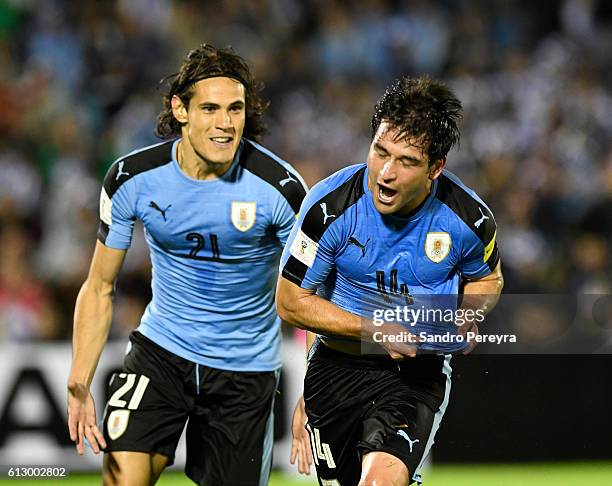 Nicolas Lodeiro of Uruguay celebrates with teammate Edinson Cavani after scoring the first goal of his team during a match between Uruguay and...