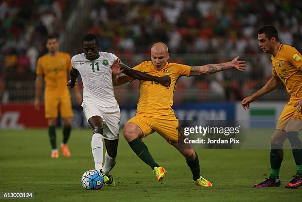 Australian player Aaron Mooy competes with Saudi Abdulamlek Al Khaibri during the match between Saudi Arabia and Australia for the FIFA World Cup...