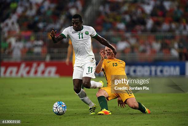 Australian player Aaron Mooy competes with Saudi Abdulamlek Al Khaibri during the match between Saudi Arabia and Australia for the FIFA World Cup...