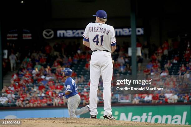 Jake Diekman of the Texas Rangers reacts as Jose Bautista of the Toronto Blue Jays runs the bases after hitting a three run home run to left field...