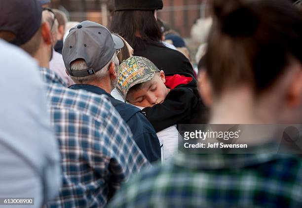 Young boy sleeps in his father's arms while Republican candidate for Vice President Mike Pence after her spoke to close to 250 supporters at a rally...
