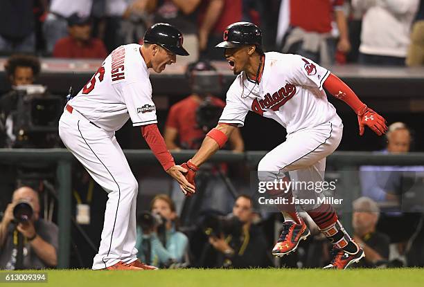 Francisco Lindor of the Cleveland Indians celebrates with third base coach Mike Sarbaugh after hitting a solo home run in the third inning against...