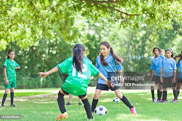focused female  soccer players face off - play off stock pictures, royalty-free photos & images