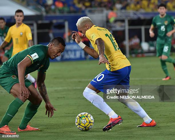 Brazil's Neymar is marked by Bolivia's Edemir Rodriguez during their Russia 2018 World Cup football qualifier match in Natal, Brazil, on October 6,...