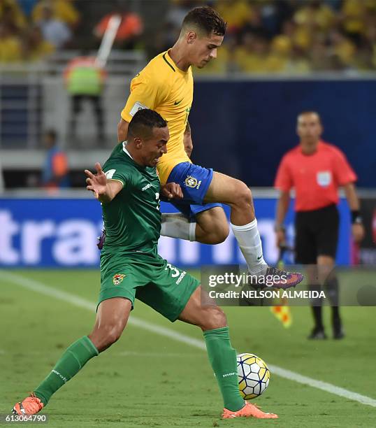 Bolivia's Edemir Rodriguez and Brazil's Philippe Coutinho vie for the ball during their Russia 2018 World Cup football qualifier match in Natal,...