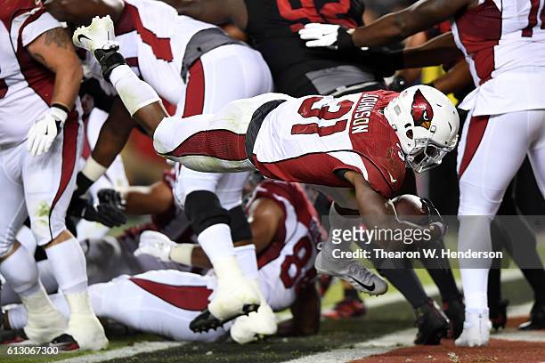 David Johnson of the Arizona Cardinals dives into the endzone for a touchdown against the San Francisco 49ers during their NFL game at Levi's Stadium...
