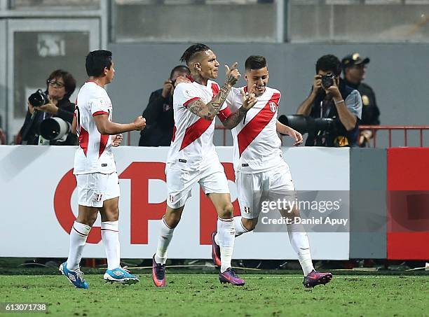 Paolo Guerrero of Peru celebrates with teammates Edison Flores and Alberto Da Silva after scoring the first goal of his team during a match between...