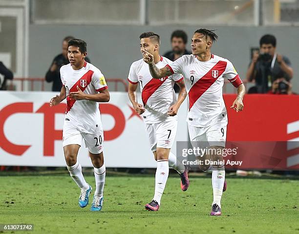 Paolo Guerrero of Peru celebrates with teammates Edison Flores and Alberto Da Silva after scoring the first goal of his team during a match between...