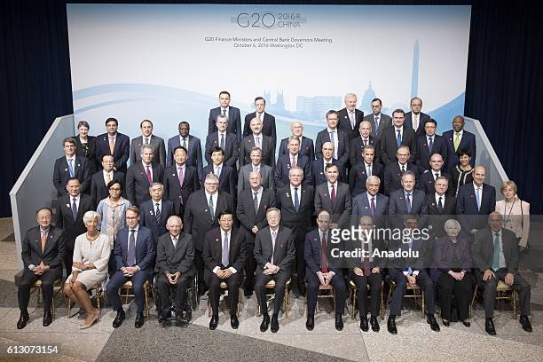 Finance Minister and Central Bank Governors group members pose for a photo during World Bank-IMF Annual Meetings at IMF headquarters in Washington,...
