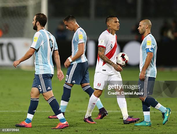 Gonzalo Higuain, Ramiro Funes Mori and Javier Mascherano of Argentina walk off the field as Paolo Guerrero of Peru holds the ball after a match...