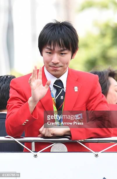 Koki Niwa waves on the top of a double decker bus during the Rio Olympic Paralympic 2016 Japanese medalist parade in the ginza district on October 7,...
