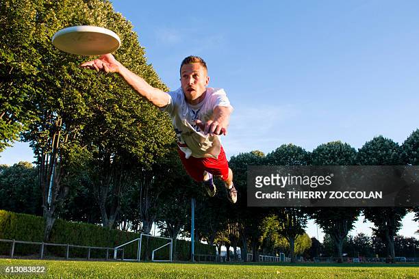 French frisbee champion Pierre Lemerle catches a frisbee in Clermont-Ferrand on October 3, 2016. Lemerle, a member of the French "ultimate" team is...