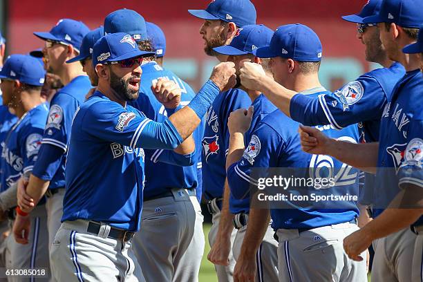Toronto Blue Jays right fielder Jose Bautista fist bumps his teammates while being introduced prior to game 1 of the ALDS between the Toronto Blue...