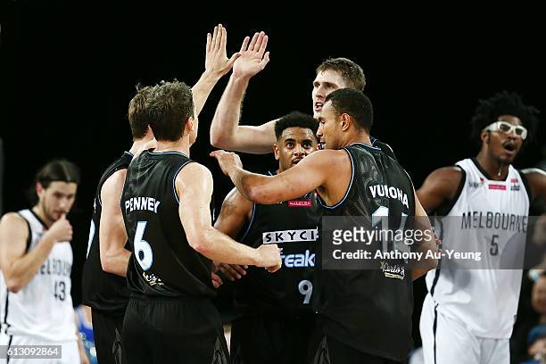 Mika Vukona, Kirk Penney and Corey Webster of New Zealand celebrate during the round one NBL match between the New Zealand Breakers and Melbourne...