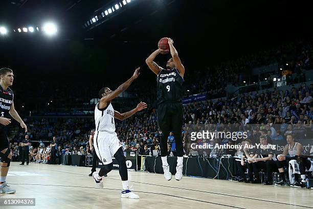 Corey Webster of New Zealand takes a three pointer against Ramone Moore of Melbourne during the round one NBL match between the New Zealand Breakers...