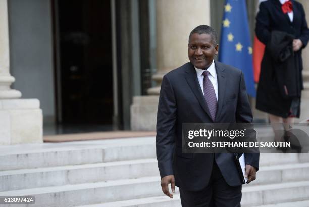 Nigerian businessman and Africa's richest man Aliko Dangote leaves the Elysee presidential Palace following a meeting between French President and...