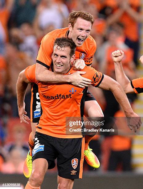 Luke DeVere of the Roar is congratulated by team mates after scoring a goal during the round one A-League match between the Brisbane Roar and...