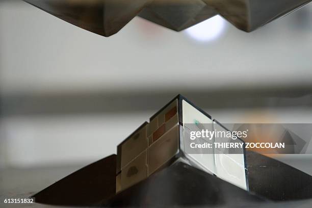 Photo taken on July 11, 2016 shows the jaws of a 1,500 ton multi-anvil press closing on a sample held between eight cubes of tungsten carbide at the...