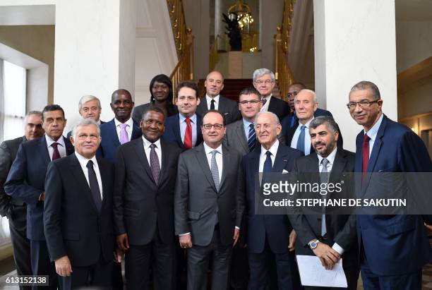 French President Francois Hollande pose with CEO of Tunisia's PIRECO company Abdessalem Ben Ayed , Nigerian businessman and Africa's richest man...