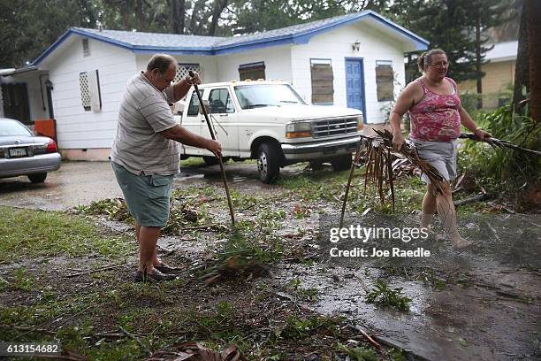 Jim Griggis and Marlin Whaley clean up after Hurricane Matthew passed through the area on October 7, 2016 in Fort Pierce, Florida. The hurricane is...