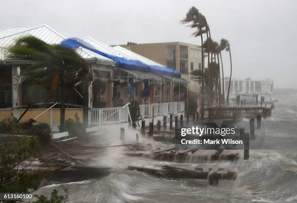 Heavy waves caused by Hurricane Matthew pounds the boat docks at the Sunset Bar and Grill, October 7, 2016 on Cocoa Beach, Florida. Hurricane Matthew...