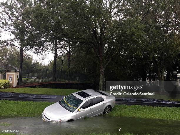Car rests in a ditch off 17/92 in the Longwood/Lake Mary area in front of the Wyndham Place apartments on Friday, Oct. 7, 2016 in Longwood, Fla.