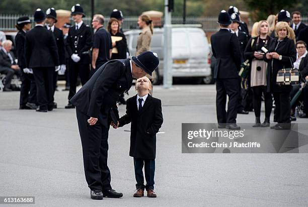 Police cadet David Thompson gets a kiss from his son David before the start of the Metropolitan Police 'Passing Out Parade' outside Peel House at...