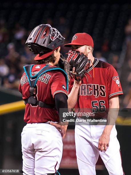 Relief pitcher Steve Hathaway and Tuffy Gosewisch of the Arizona Diamondbacks have a meeting on the mound in the seventh inning of the MLB game...