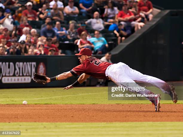 Jake Lamb of the Arizona Diamondbacks dives for the ball in the seventh inning of the MLB game against the San Diego Padres at Chase Field on October...