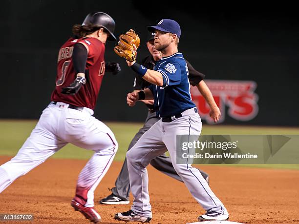 Second baseman Ryan Schimpf of the San Diego Padres covers first base and makes the out against Tuffy Gosewisch of the Arizona Diamondbacks in the...