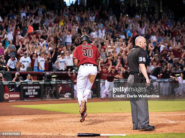 Socrates Brito of the Arizona Diamondbacks slides home safely to score the winning run in the ninth inning of the MLB game against the San Diego...