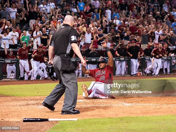 Socrates Brito of the Arizona Diamondbacks slides home safely to score the winning run in the ninth inning of the MLB game against the San Diego...