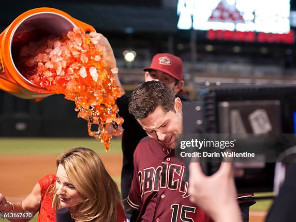 Phil Gosselin of the Arizona Diamondbacks is showered with gatorade by his teammates during an interview after a walk-off single in the ninth inning...