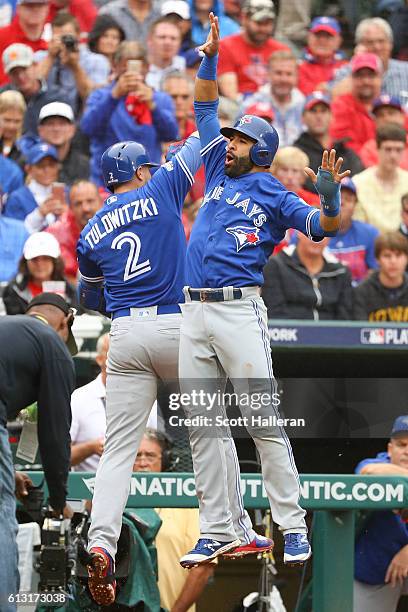 Troy Tulowitzki of the Toronto Blue Jays celebrates with Jose Bautista after hitting a home run against the Texas Rangers in the second inning of...