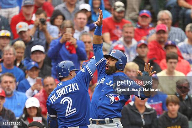 Troy Tulowitzki of the Toronto Blue Jays celebrates with Jose Bautista after Tulowitzki hit a home run against the Texas Rangers in the second inning...