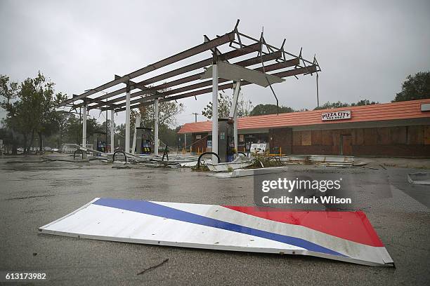 Metal lies on the ground at a gas station damaged by the heavy winds of Hurricane Matthew, October 7, 2016 on Port Orange, Florida. Hurricane Matthew...