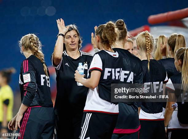 Head coach Anouschka Bernhard of Germany celebrates with team mates after winning the FIFA U-17 Women's World Cup Group B match between Germany and...