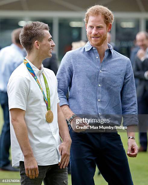 Olympic gold medal gymnast Max Whitlock and Prince Harry attend an event to mark the expansion of the Coach Core sports coaching apprenticeship...