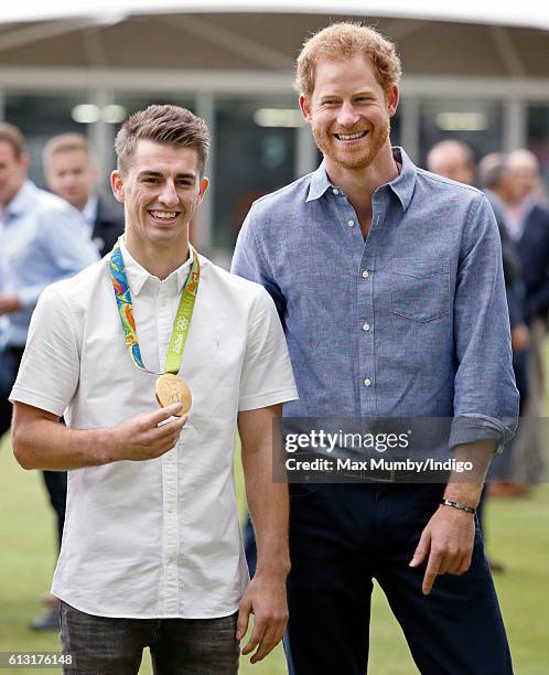 Olympic gold medal gymnast Max Whitlock and Prince Harry attend an event to mark the expansion of the Coach Core sports coaching apprenticeship...